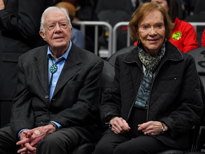 caption: After being taken to a hospital for observation and treatment of a minor pelvic fracture, former President Jimmy Carter "is in good spirits and is looking forward to recovering at home," the Carter Center says. He's seen here with his wife, Rosalynn Carter, earlier this year.