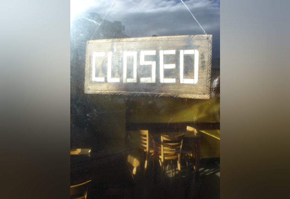 caption: Closed sign hanging in restaurant window