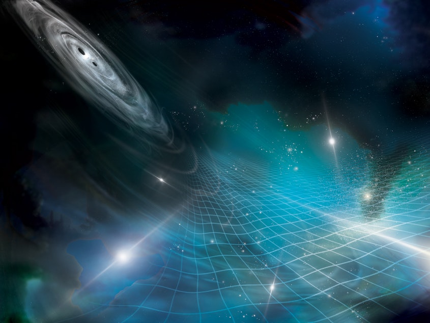 caption: This artist's impression shows a pair of supermassive black holes circling each other and sending out gravitational waves, which affect the bright, shining pulsars.