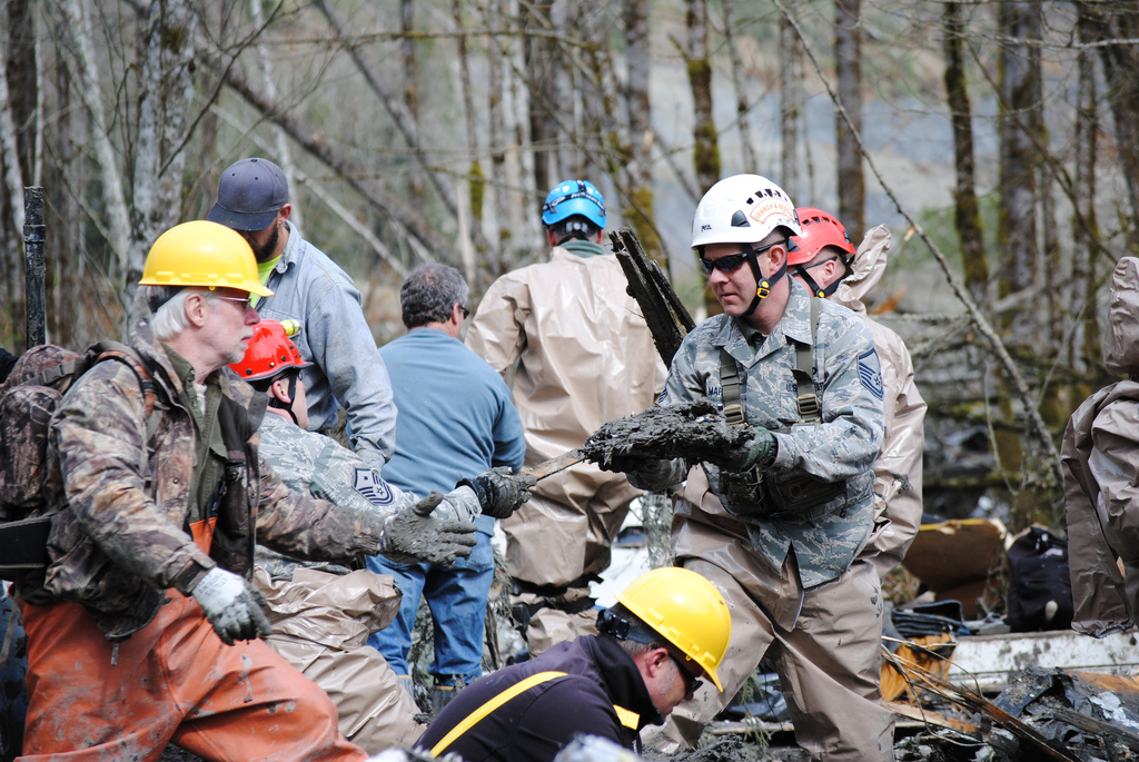 caption: Search and rescue workers on the west side of slide.