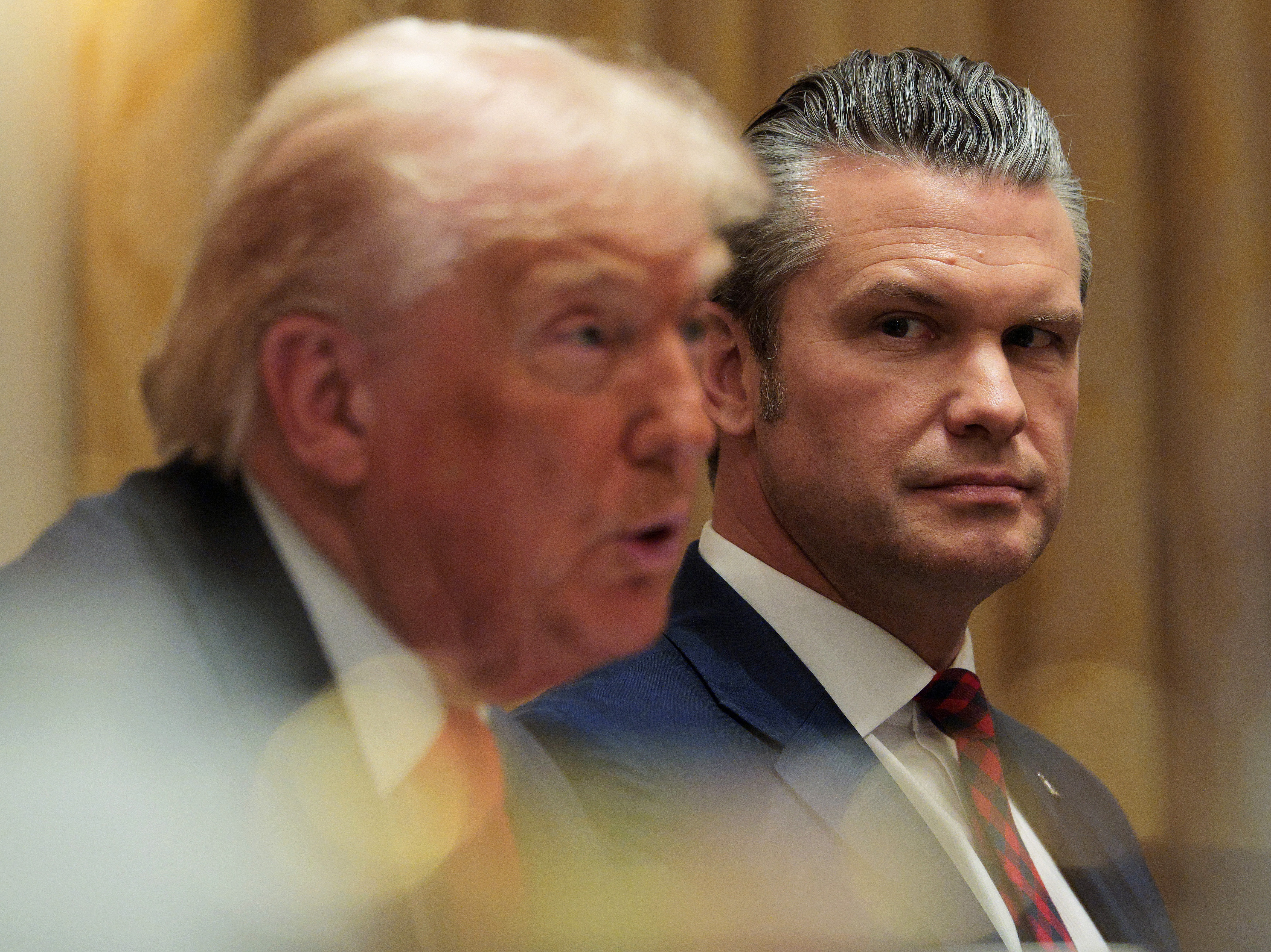 caption: Secretary of Defense Pete Hegseth looks on as President Trump speaks during a Cabinet meeting at the White House on Wednesday.