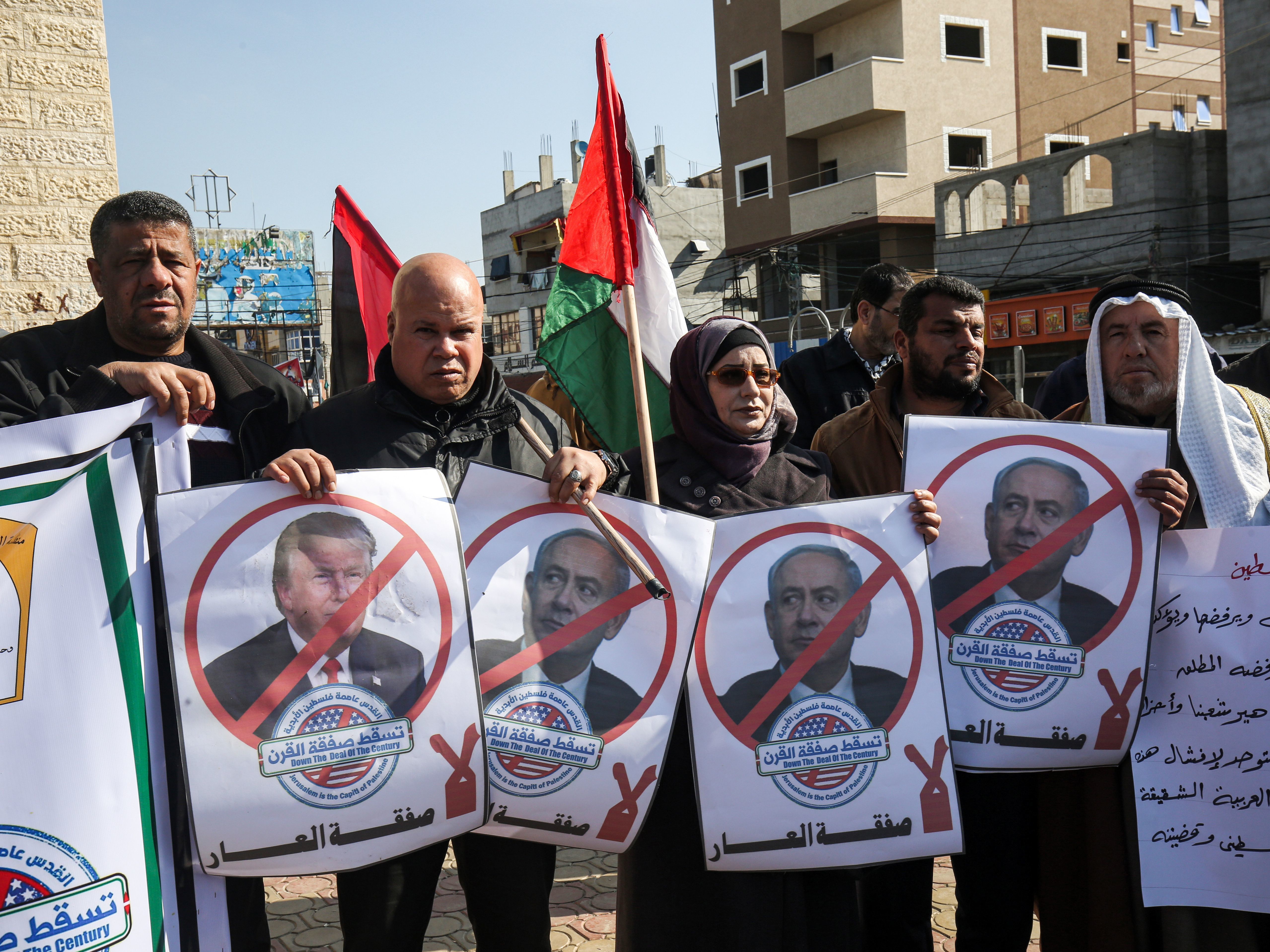 caption: Palestinian demonstrators in Rafah, in the southern Gaza strip, hold portraits of President Trump and Israeli Prime Minister Benjamin Netanyahu during a protest against Trump's expected announcement of a peace plan on Tuesday.