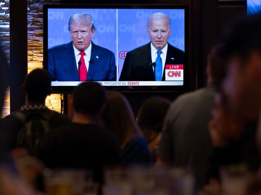 caption: Guests at the Old Town Pour House watch a debate between President Biden and former President Donald Trump on Thursday in Chicago. The debate is the first of two scheduled between the two candidates before the November election.