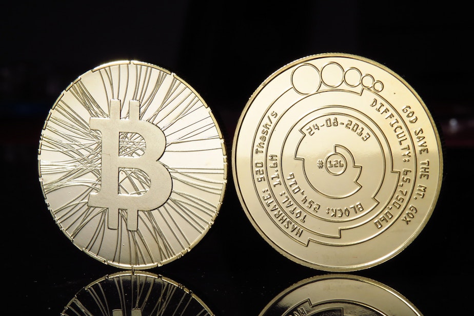 caption: Not a real bitcoin: the currency doesn't have a physical form; pictures like this are novelty items that often have bitcoin information on them.