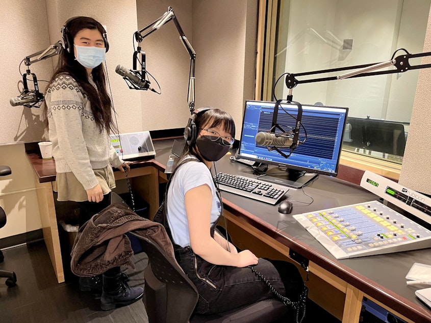caption: Emily Chua (left) and Alayna Ly record narration in a KUOW studio on May 7, 2022 as part of the RadioActive Advanced Producers Workshop.