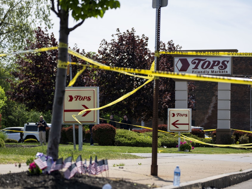 caption: Police tape surrounds Tops Friendly Market the day after the fatal shooting of 10 people on May 14 in Buffalo, N.Y.