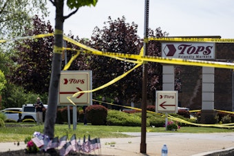 caption: Police tape surrounds Tops Friendly Market the day after the fatal shooting of 10 people on May 14 in Buffalo, N.Y.