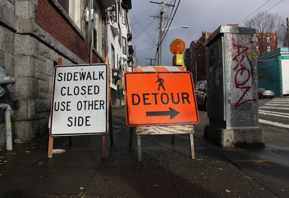 caption: Mark Adreon took KUOW on a walk through Capitol Hill to demonstrate how hard it is being blind and navigating the endless construction sites in the city. When he arrived at this spot, the placards through him off course.