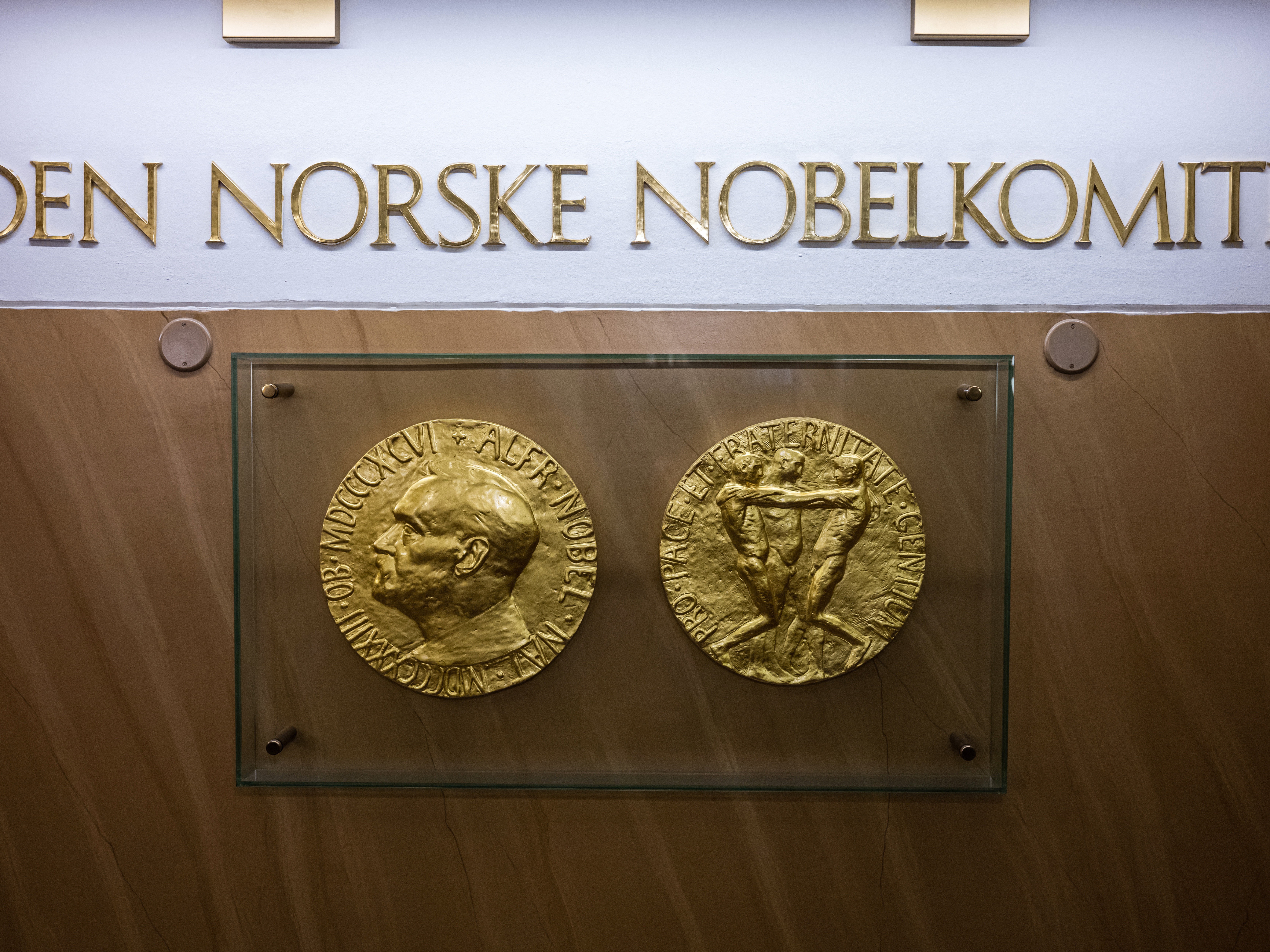 caption: Replicas of the obverse and reverse of the Nobel Peace Prize medal displayed at The Norwegian Nobel Institute in Oslo.