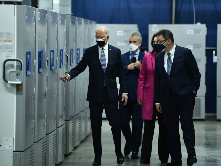 caption: President Biden inspects COVID-19 vaccine freezers at a Pfizer plant in Kalamazoo, Mich., with White House Coronavirus Response Coordinator Jeffrey Zients, Michigan Gov. Gretchen Whitmer and Pfizer CEO Albert Bourla on Feb. 19.