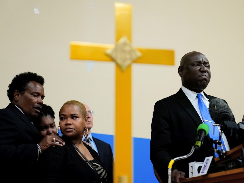 caption: Attorney Benjamin Crump, accompanied by the family of Ruth Whitfield, a victim of shooting at a supermarket, speaks with members of the media during a news conference in Buffalo, N.Y., on Monday.