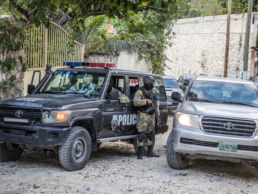 caption: Police stand guard outside the residence of the late Haitian President Jovenel Moïse in Port-au-Prince on July 15 in the wake of his assassination on July 7.