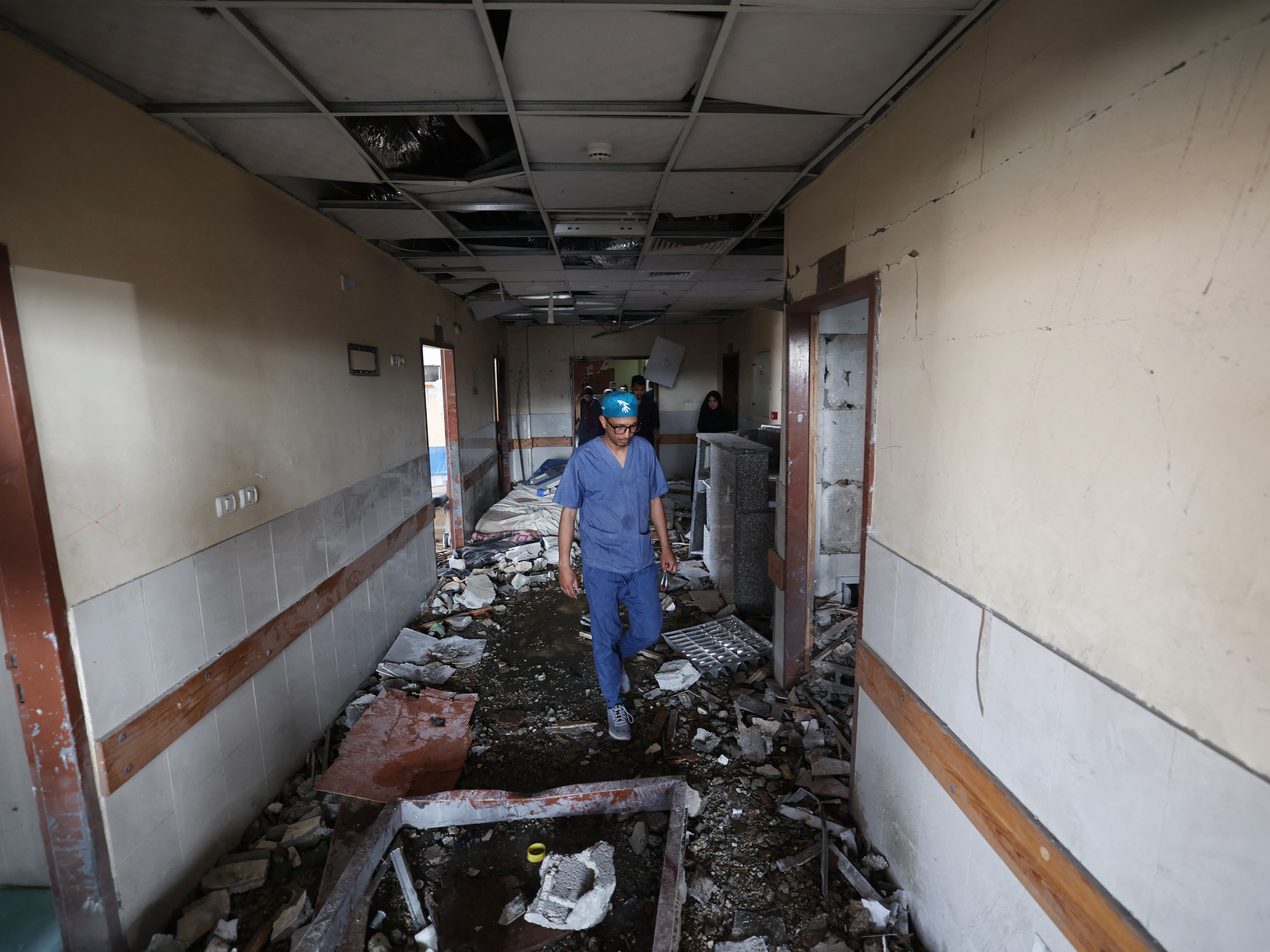 caption: Palestinian hospital staff inspect the destruction inside Nasser hospital in Khan Younis in the southern Gaza Strip, following an Israeli strike on May 13.