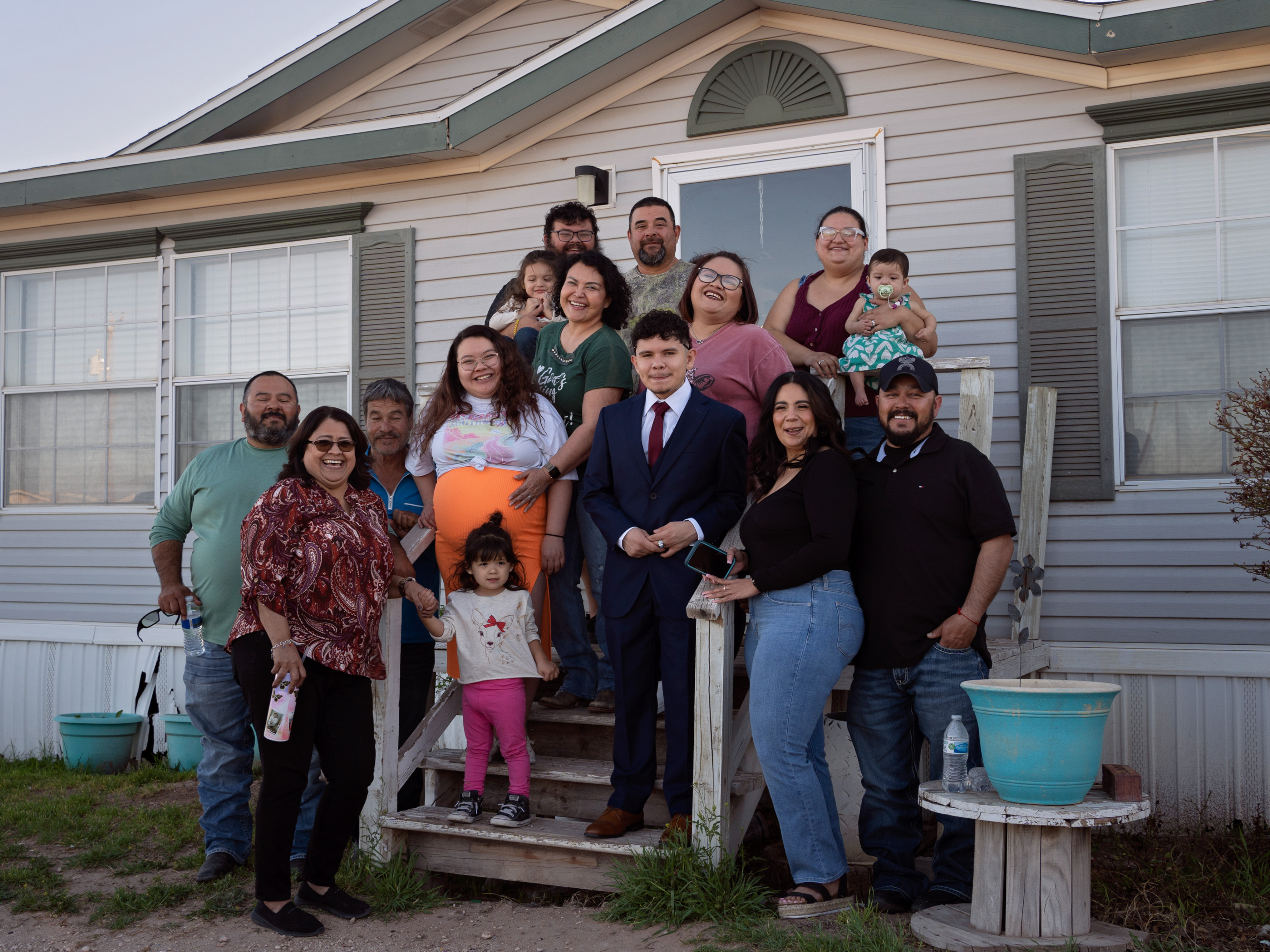 caption: Caitlynn Almance (wearing orange) poses for a portrait with family members at her parents' home in Odessa, Texas. "The bond my siblings have with each other — it's just the most beautiful bond ever," says Caitlynn, who was six months pregnant in this photo taken in early March.