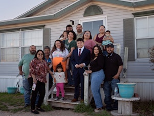 caption: Caitlynn Almance (wearing orange) poses for a portrait with family members at her parents' home in Odessa, Texas. "The bond my siblings have with each other — it's just the most beautiful bond ever," says Caitlynn, who was six months pregnant in this photo taken in early March.