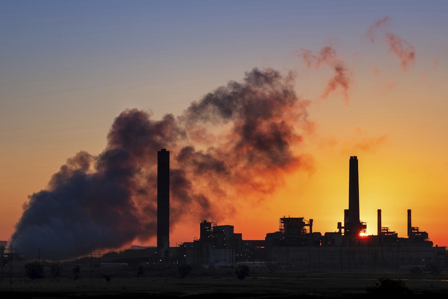 caption: In this July 27, 2018 photo, the Dave Johnson coal-fired power plant is silhouetted against the morning sun in Glenrock, Wyo. (J. David Ake/AP)