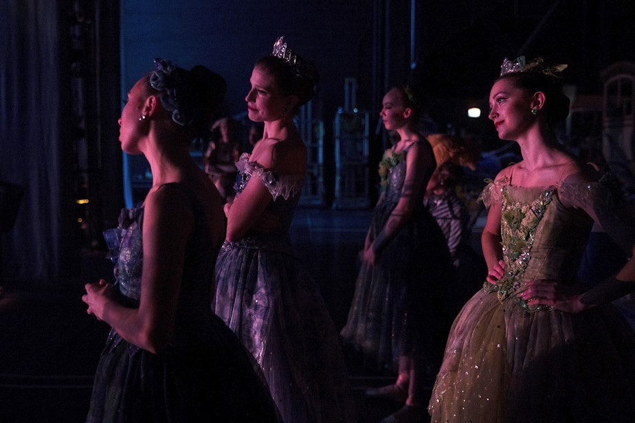 caption: Soloist Leah Merchant, second from left, and corps de ballet dancer Madison Rayn Abeo, right, watch from backstage during the final scene of Pacific Northwest Ballet's performance of Cinderella on Saturday, February 1, 2020, at McCaw Hall in Seattle.