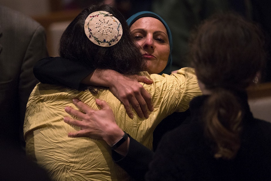 caption: Rabbi Jill Borodin, left, hugs Aneelah Afzali, with the Muslim Association of the Puget Sound, during a community vigil for Pittsburgh on Monday, October 29, 2018, at the Temple De Hirsch Sinai on 16th Avenue in Seattle.