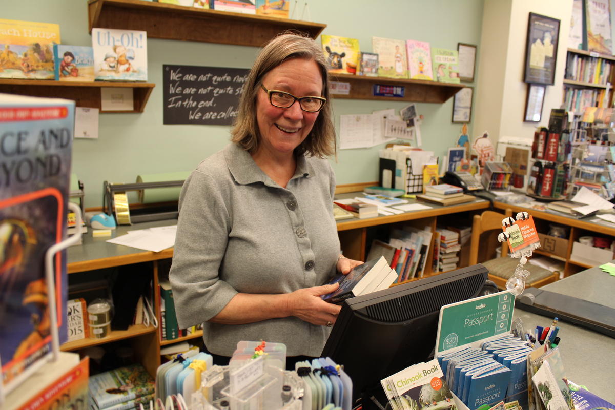 caption: Christy McDanold owns the Secret Garden Bookstore on Northwest Market Street. She bought her home in Ballard 20 years ago. Today, she says, she couldn't afford the house she lives in. "I couldn't afford a condo in Ballard today," she said.
