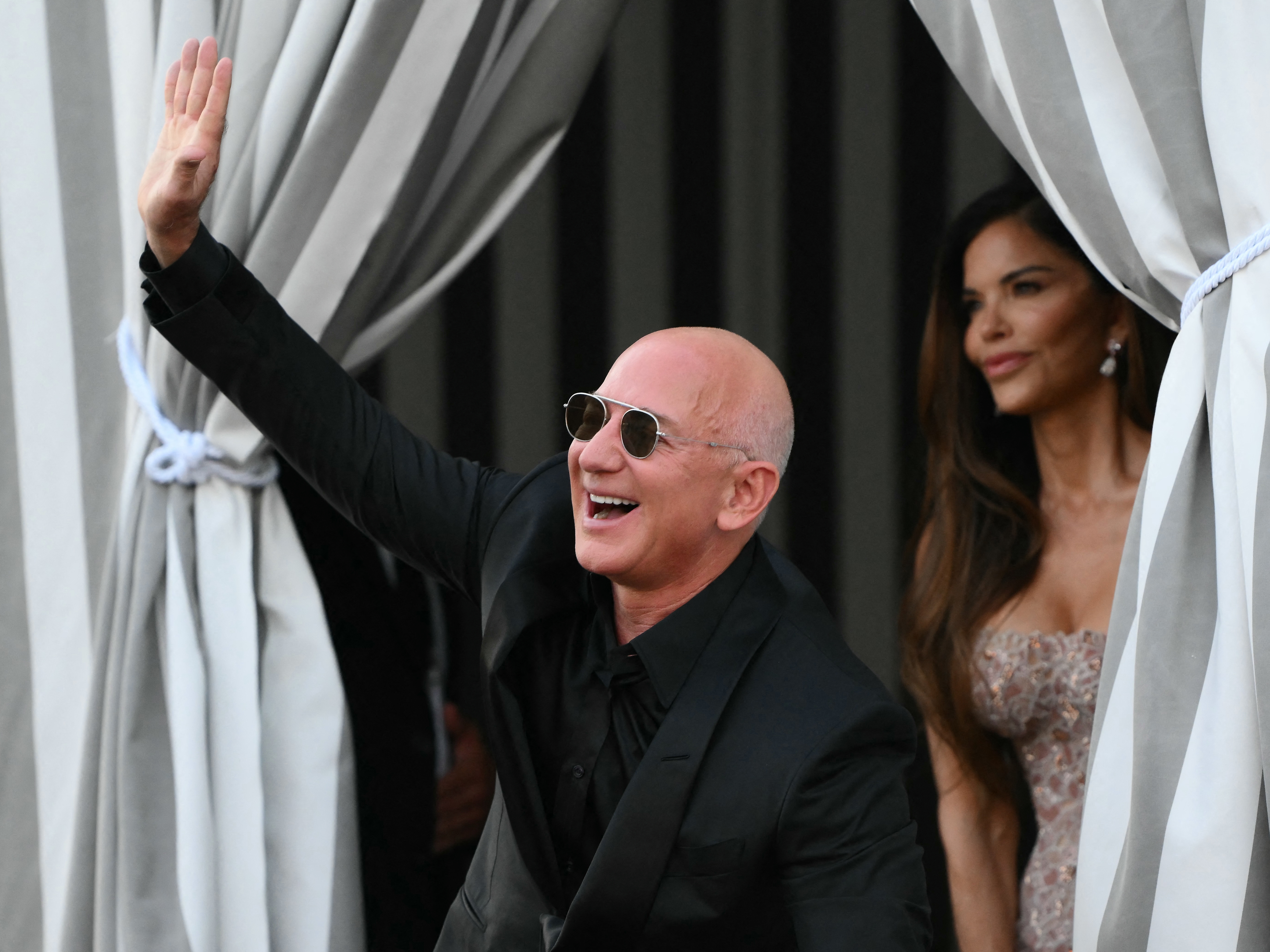caption: <em>Washington Post</em> owner Jeff Bezos and spouse Lauren Sanchez Bezos leave the Aman Hotel on the third day of their wedding festivities in Venice on June 28, 2025.