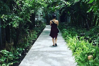 caption: Thanh Tan walking down a pathway in Hoi An, a city on the central coast of Vietnam.
