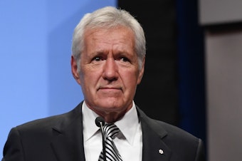 caption: <em>Jeopardy!</em> host Alex Trebek speaks as he is inducted into the National Association of Broadcasters' Broadcasting Hall of Fame in Las Vegas in April 2018. On Wednesday, he revealed that he was diagnosed with pancreatic cancer.