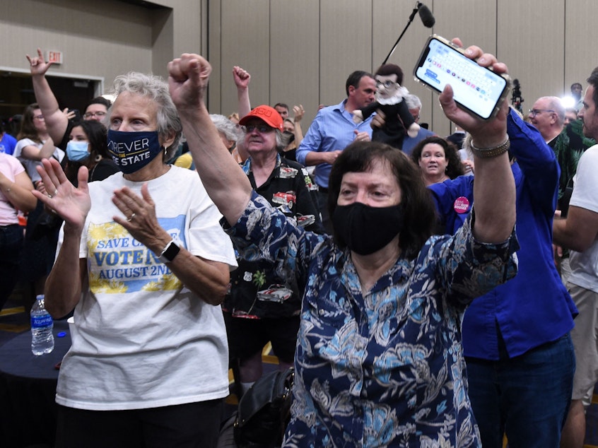 caption: Abortion-rights supporters cheer as the proposed Kansas constitutional amendment that would allow abortion restrictions in the state fails. They were watching election results at the Kansas for Constitutional Freedom watch party in Overland Park on Tuesday night.