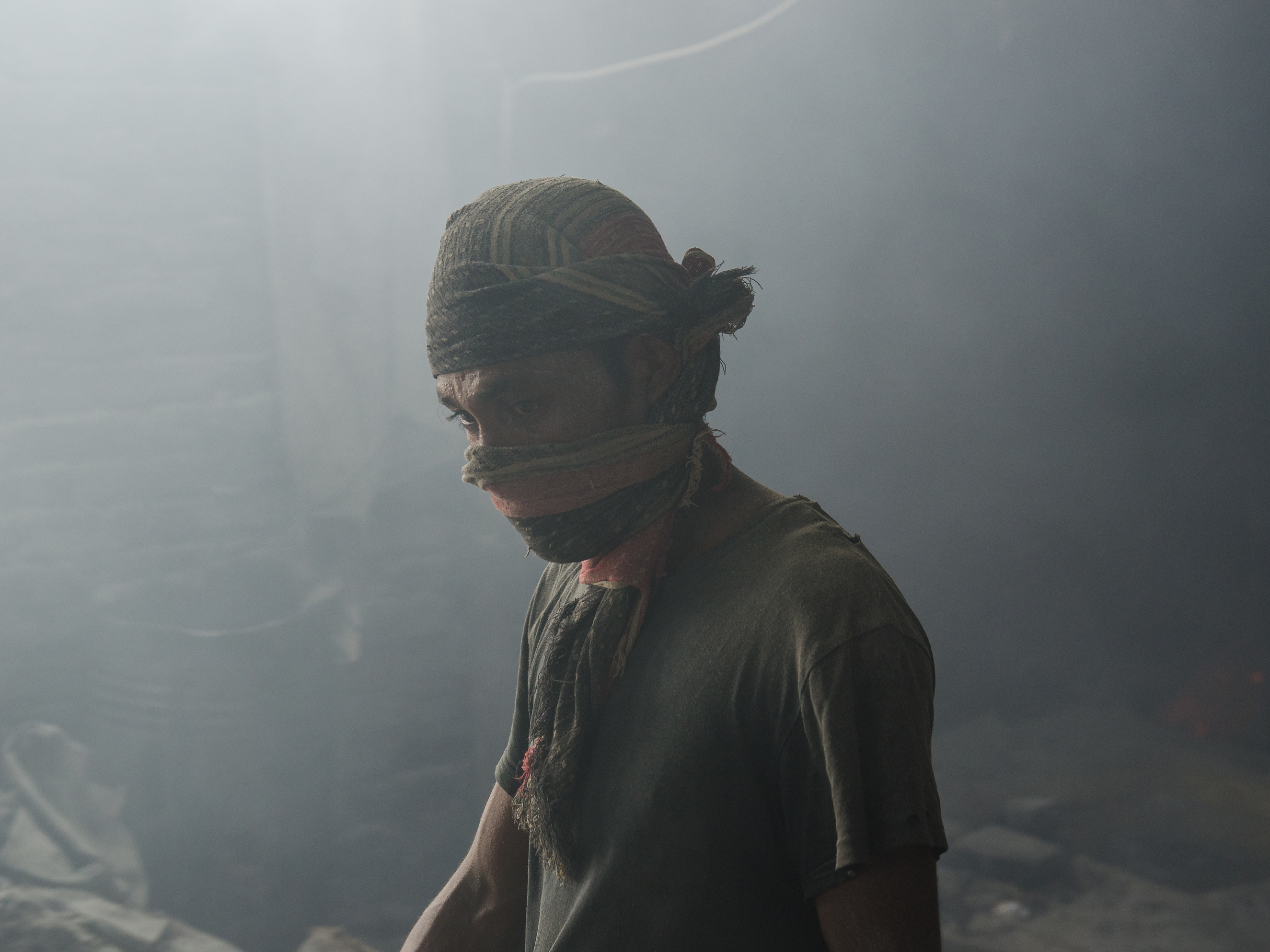caption: A worker in a Bangladeshi lead mill, without safety protection. A new analysis finds the death toll from lead exposure is about six times higher than the previous estimate.