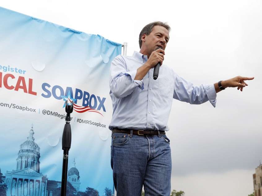 caption: Montana Gov. Steve Bullock speaks at the Des Moines Register Soapbox during a visit to the Iowa State Fair in August 2018.