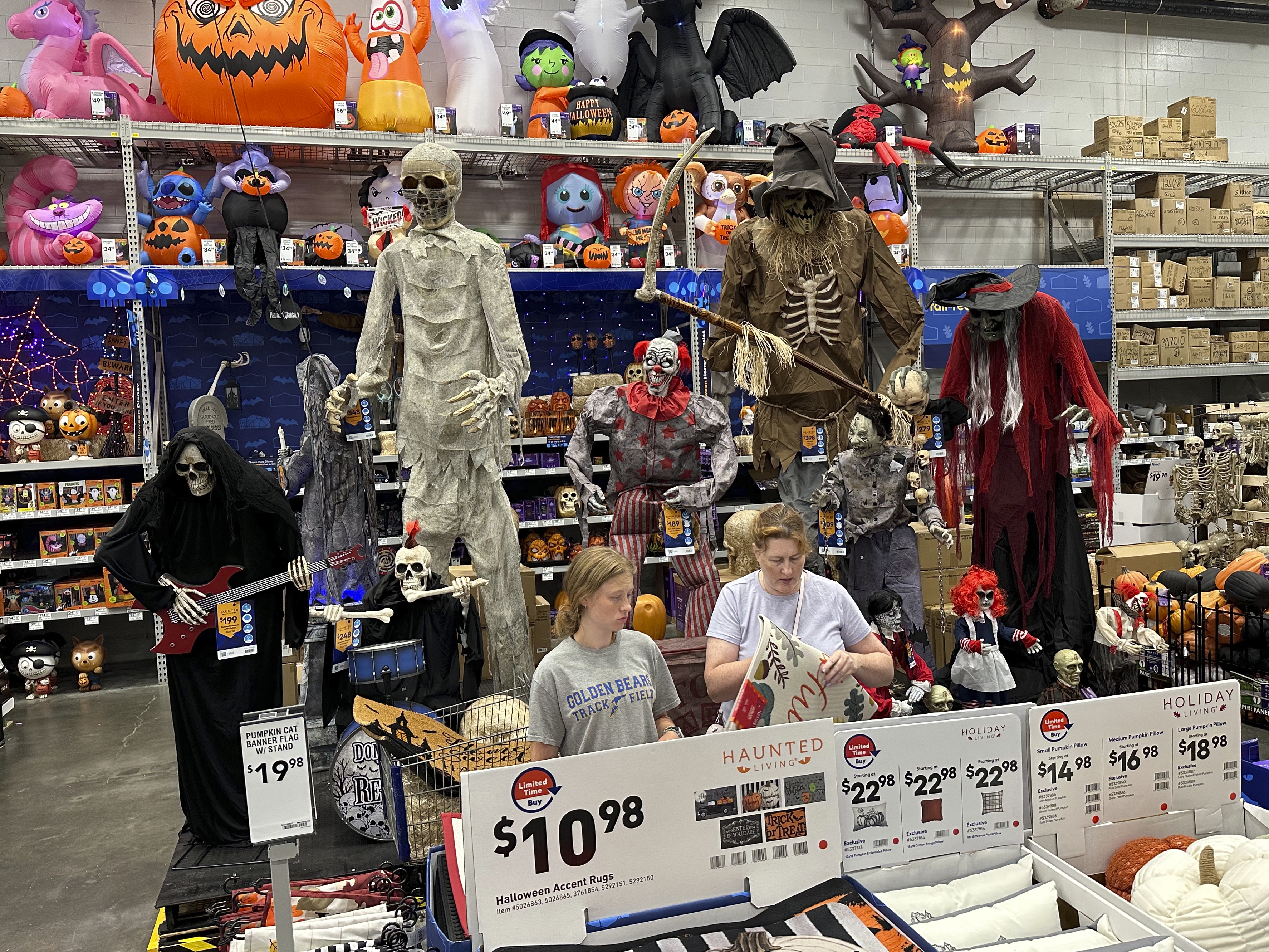 caption: People browse Halloween displays at Lowe's Home Improvement hardware store in East Rutherford, N.J., on Aug. 30, 2023.