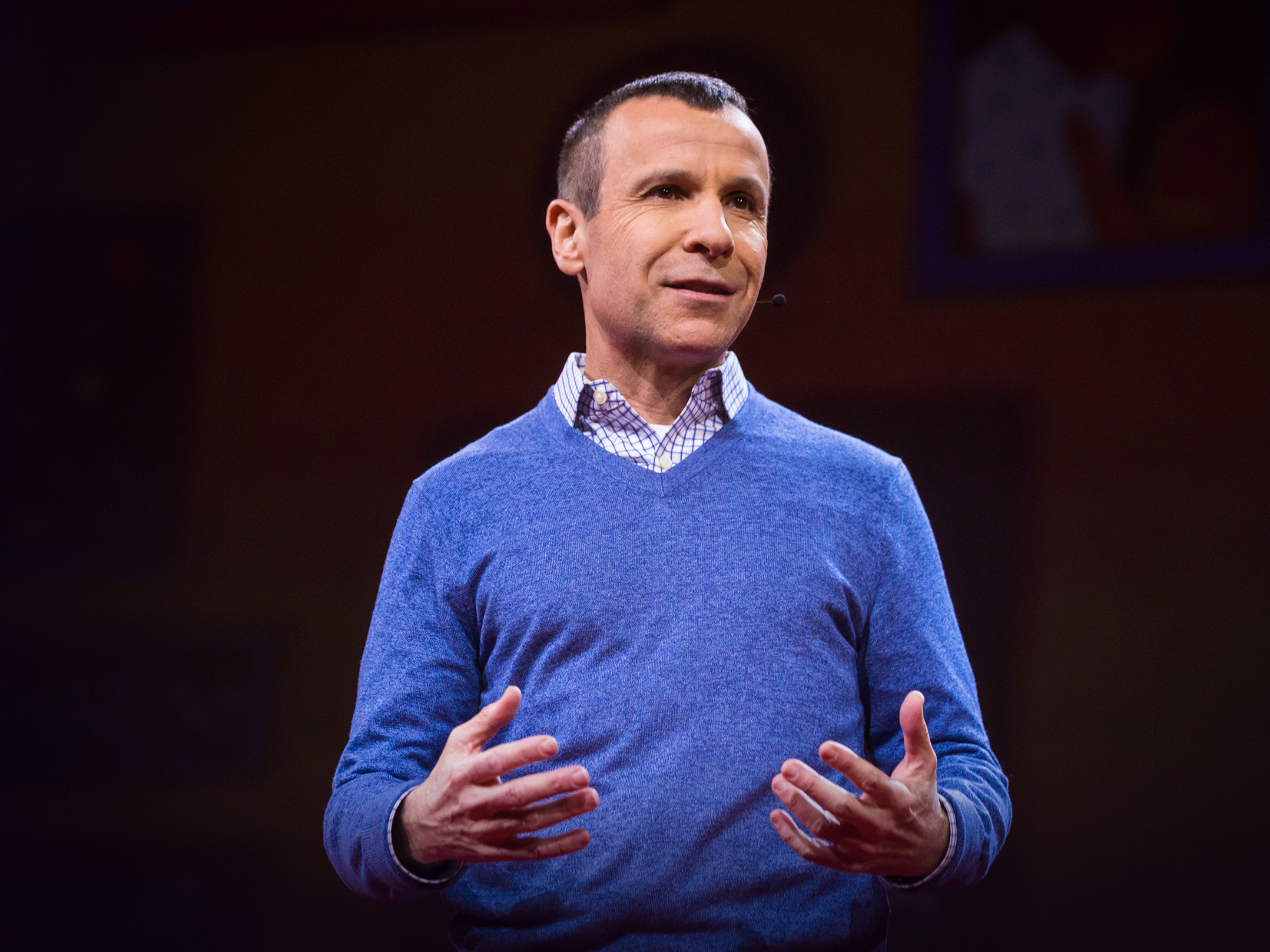 caption: Guy Winch on the TED stage.