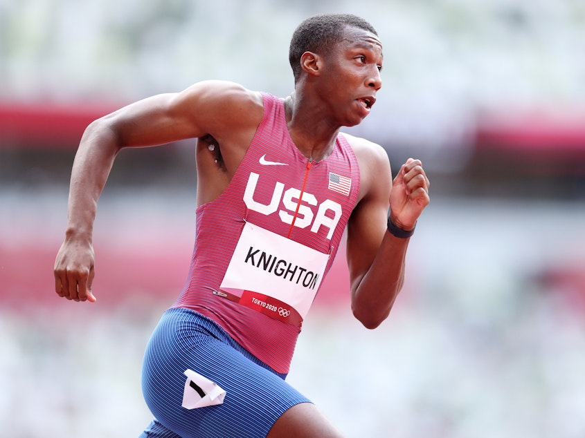 caption: U.S. sprinter Erriyon Knighton, shown here competing in a qualifying heat of the men's 200 meter at the Olympics, is racing in the final on Wednesday.
