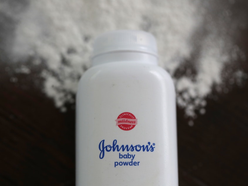 caption: In this photo illustration, a container of Johnson's baby powder sits on a table in 2019. Johnson & Johnson announced a voluntary recall of 33,000 bottles of the baby powder after federal regulators found trace amounts of asbestos in the product.