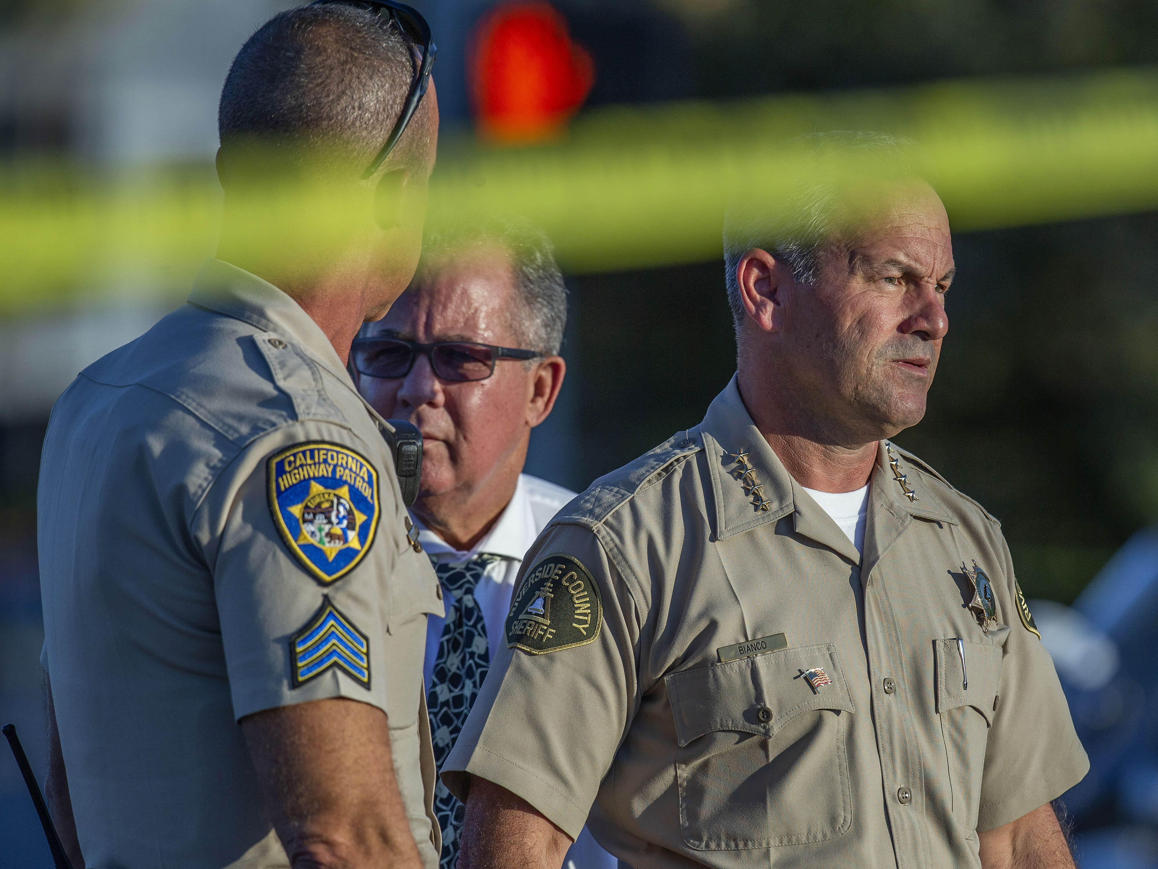 caption: Riverside County Sheriff Chad Bianco, right, with Riverside City Police Chief Sergio G. Diaz and a California Highway Patrol officer, in a photograph taken in 2019.