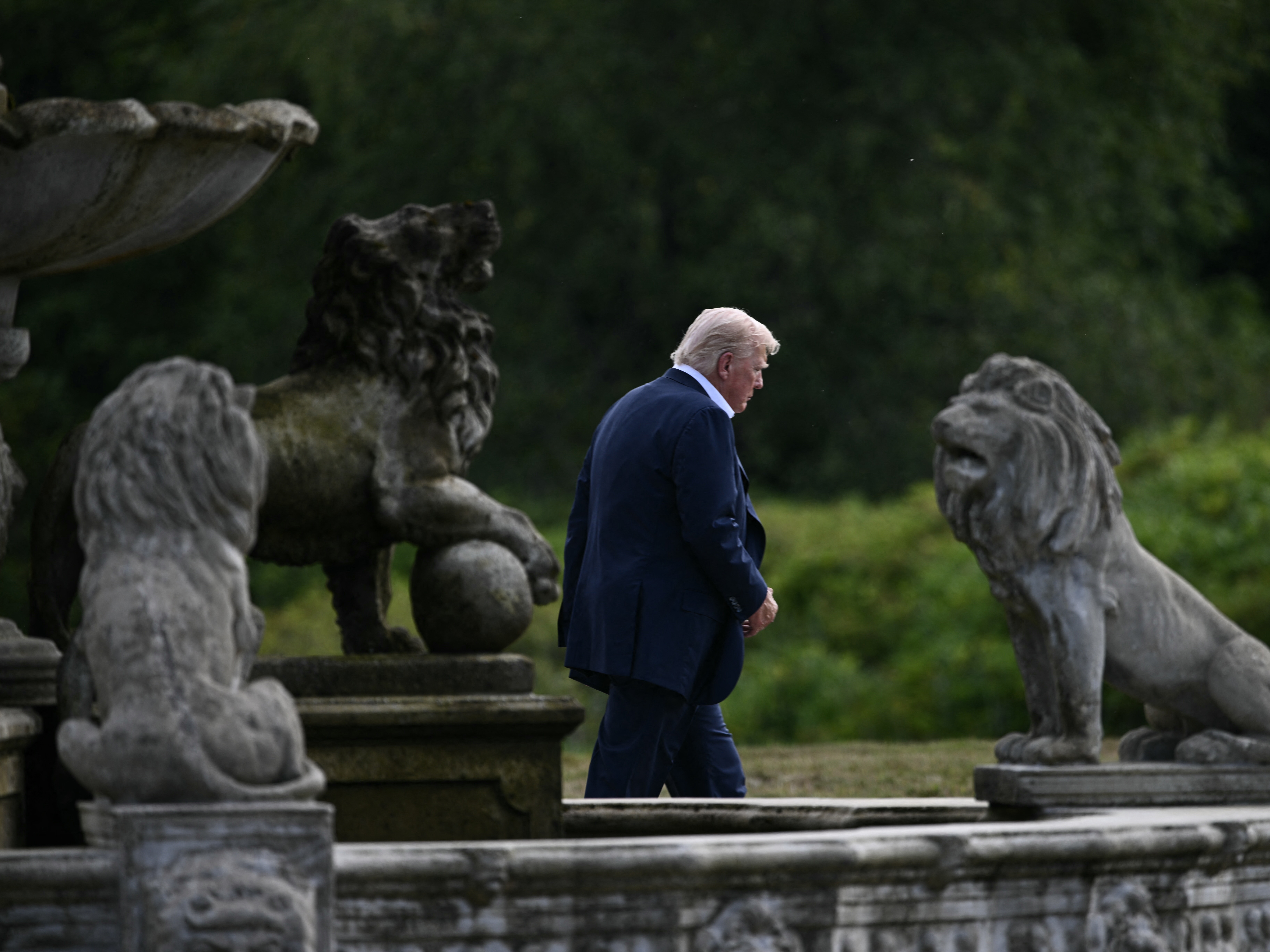 caption: President Trump walks to board Marine One at Trump International Golf Links in Balmedie, Aberdeenshire, on Tuesday at the end of his trip to Scotland.