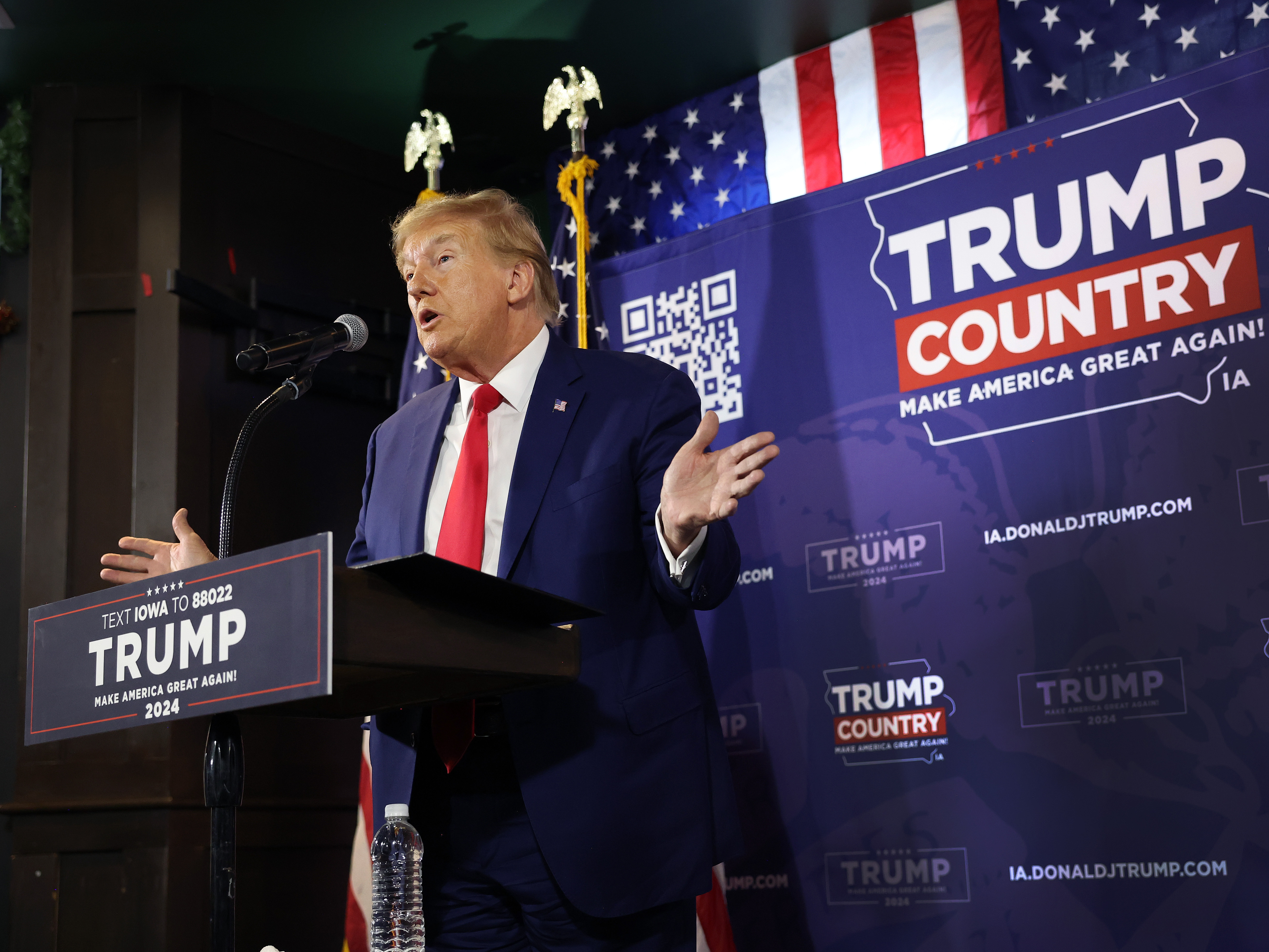 caption: Former President Donald Trump speaks at campaign campaign event in Ankeny, Iowa.