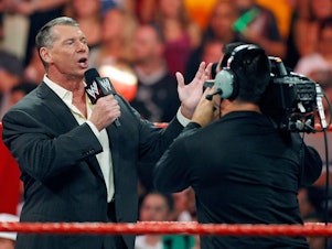 caption: World Wrestling Entertainment Inc. Chairman Vince McMahon appears in the ring in 2009 during the WWE Monday Night Raw show in Las Vegas.