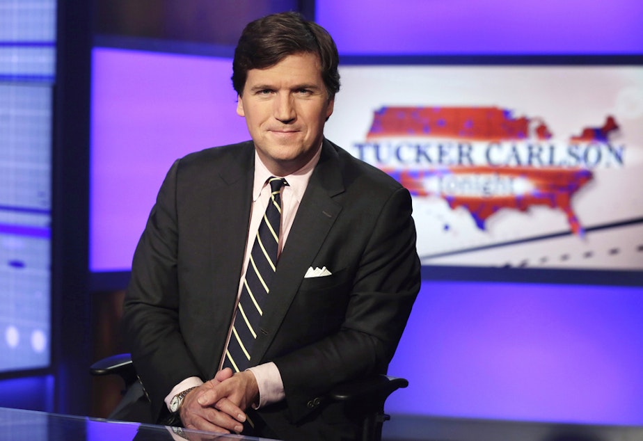caption: Tucker Carlson, host of "Tucker Carlson Tonight," poses for photos in a Fox News Channel studio on March 2, 2017, in New York. 