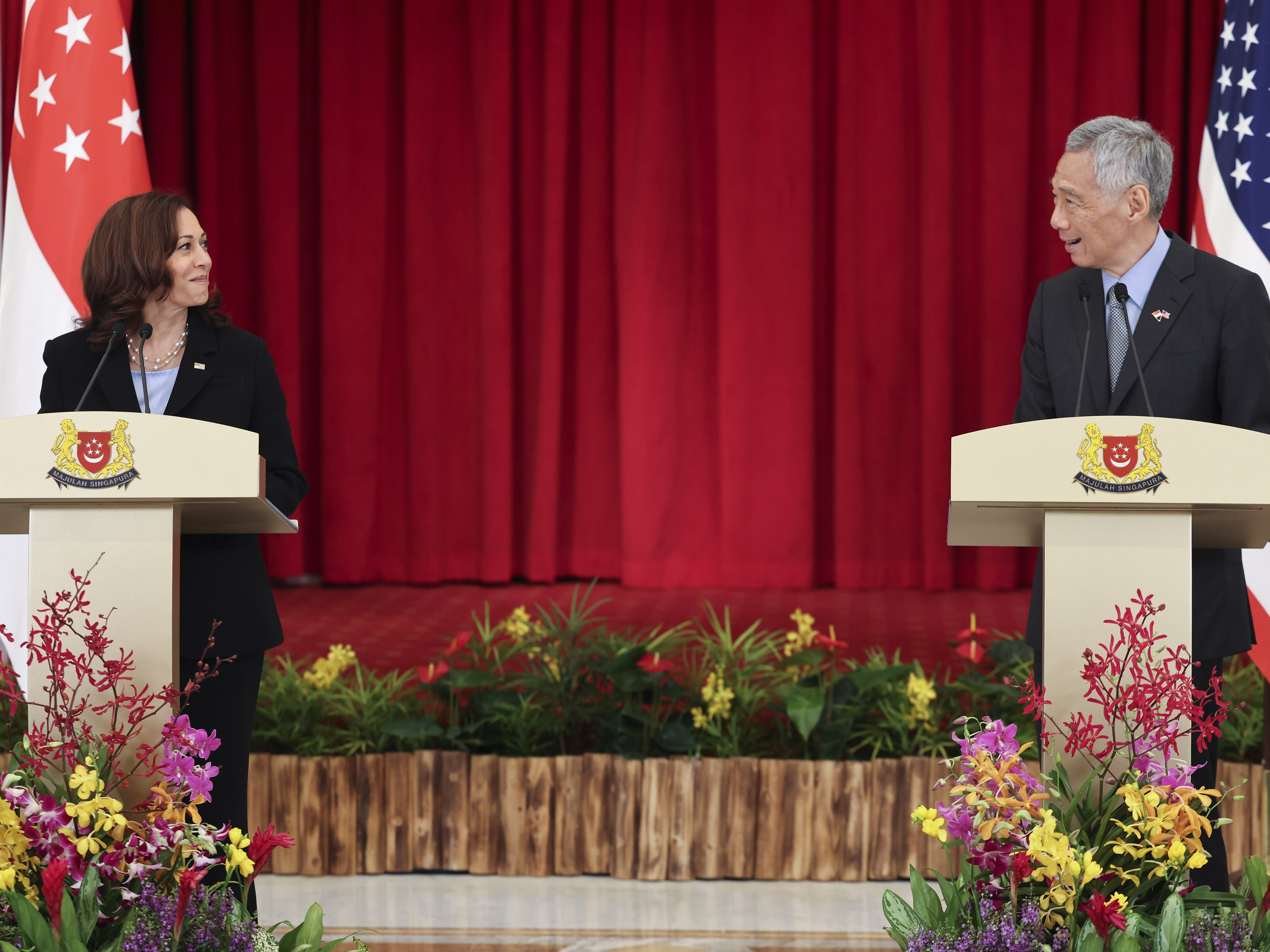 caption: U.S. Vice President Kamala Harris, left, and Singapore's Prime Minister Lee Hsien Loong hold a joint news conference in Singapore Monday, Aug. 23, 2021.
