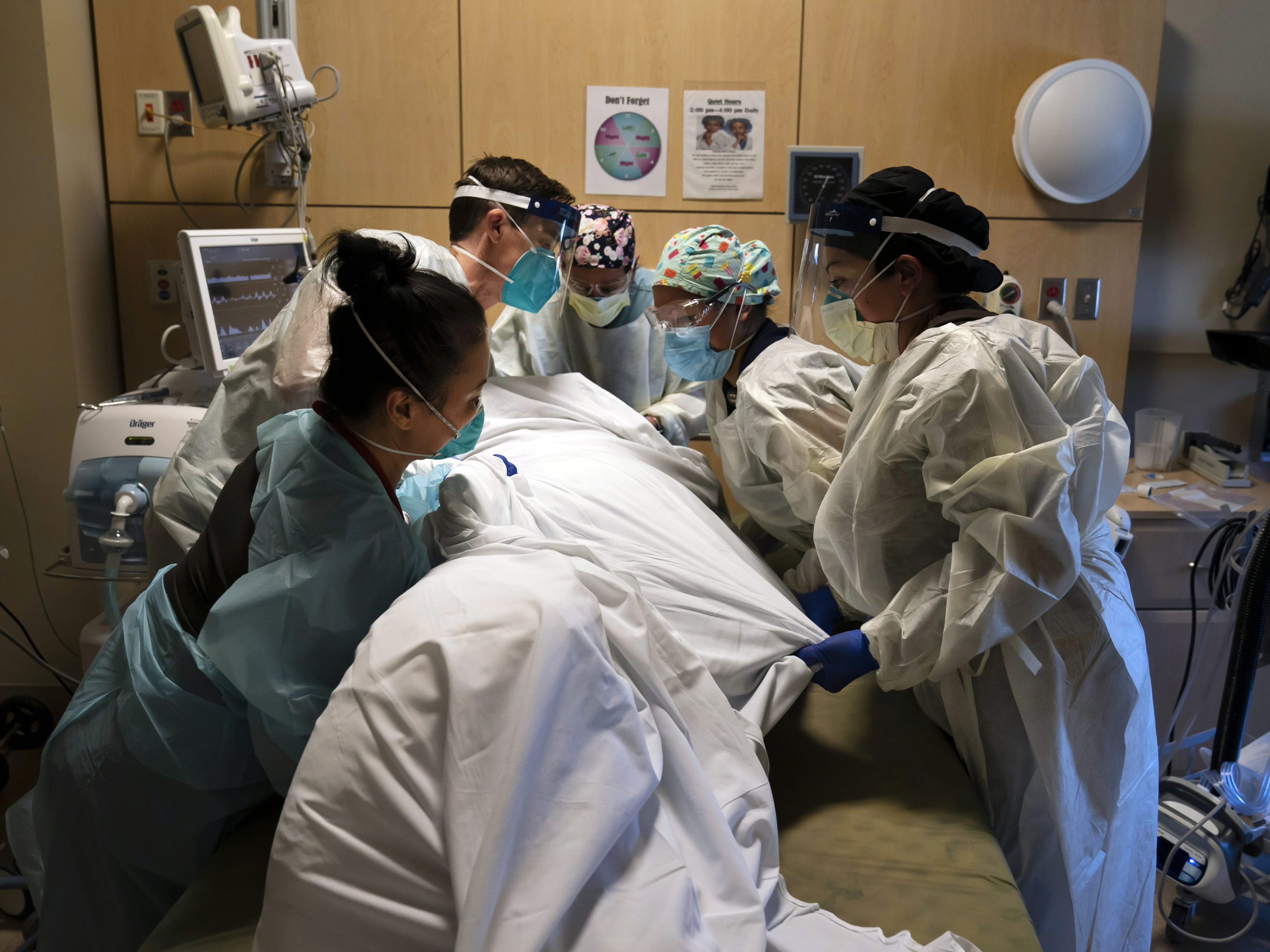 caption: Medical personnel prone a COVID-19 patient last November at Providence Holy Cross Medical Center in the Mission Hills section of Los Angeles.