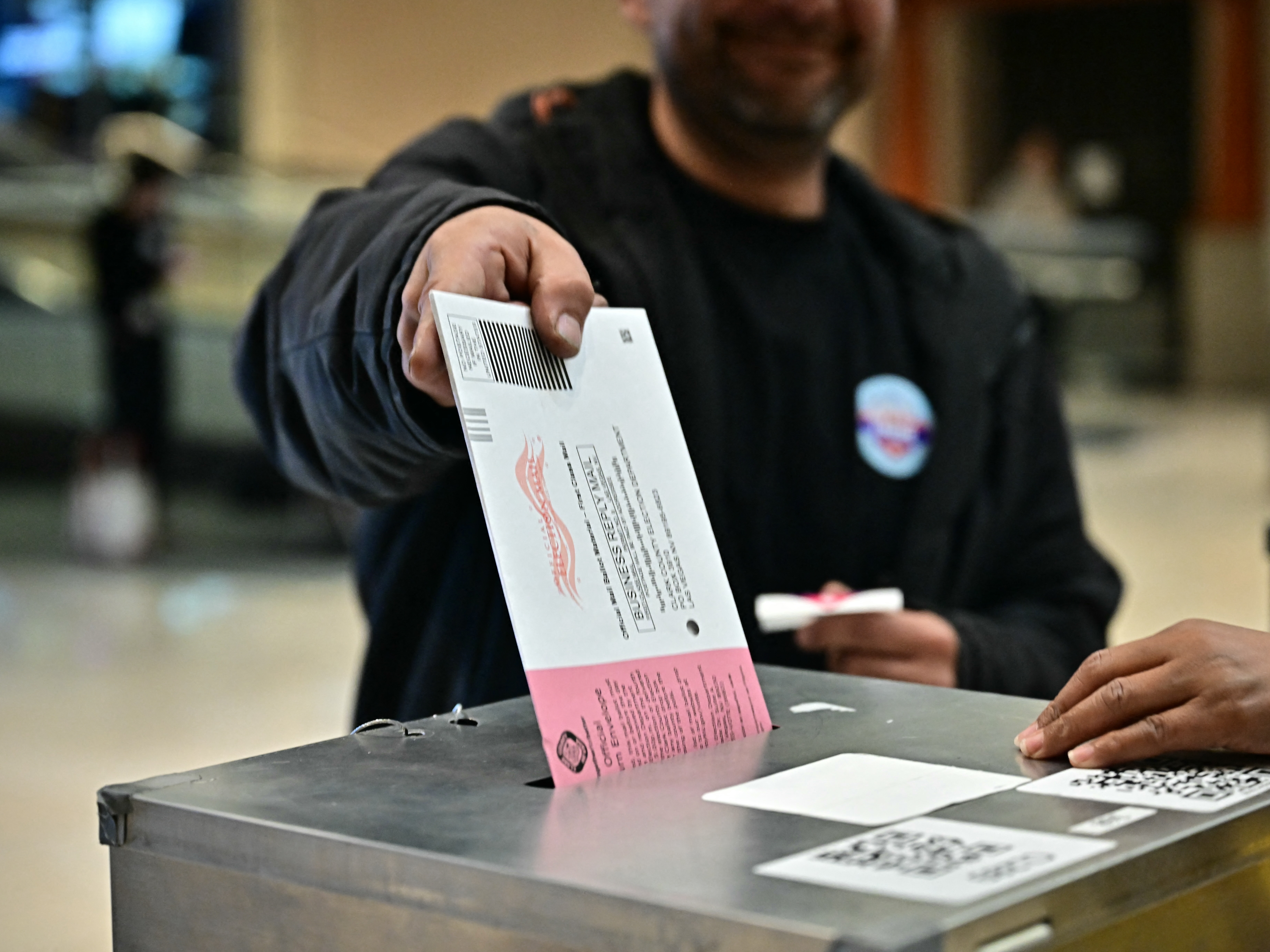 caption: People vote at a polling station at Meadows Mall in Las Vegas on Tuesday. Nevada was one of several states to vote down election reform efforts.