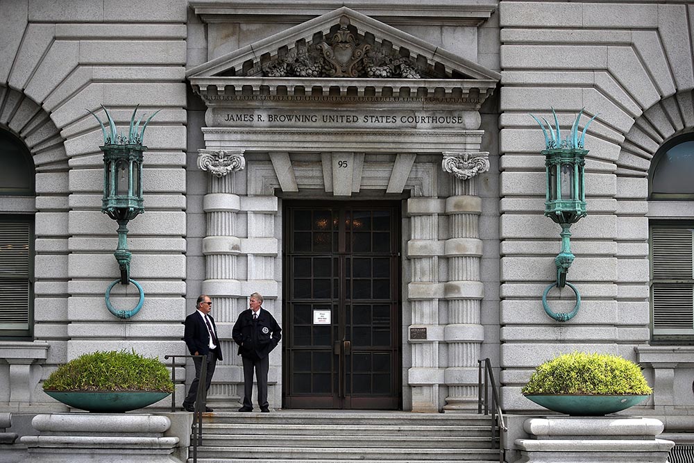 caption: Security guards stand in front of the Ninth U.S. Circuit Court of Appeals  on June 12, 2017 in San Francisco, California. (Justin Sullivan/Getty Images)