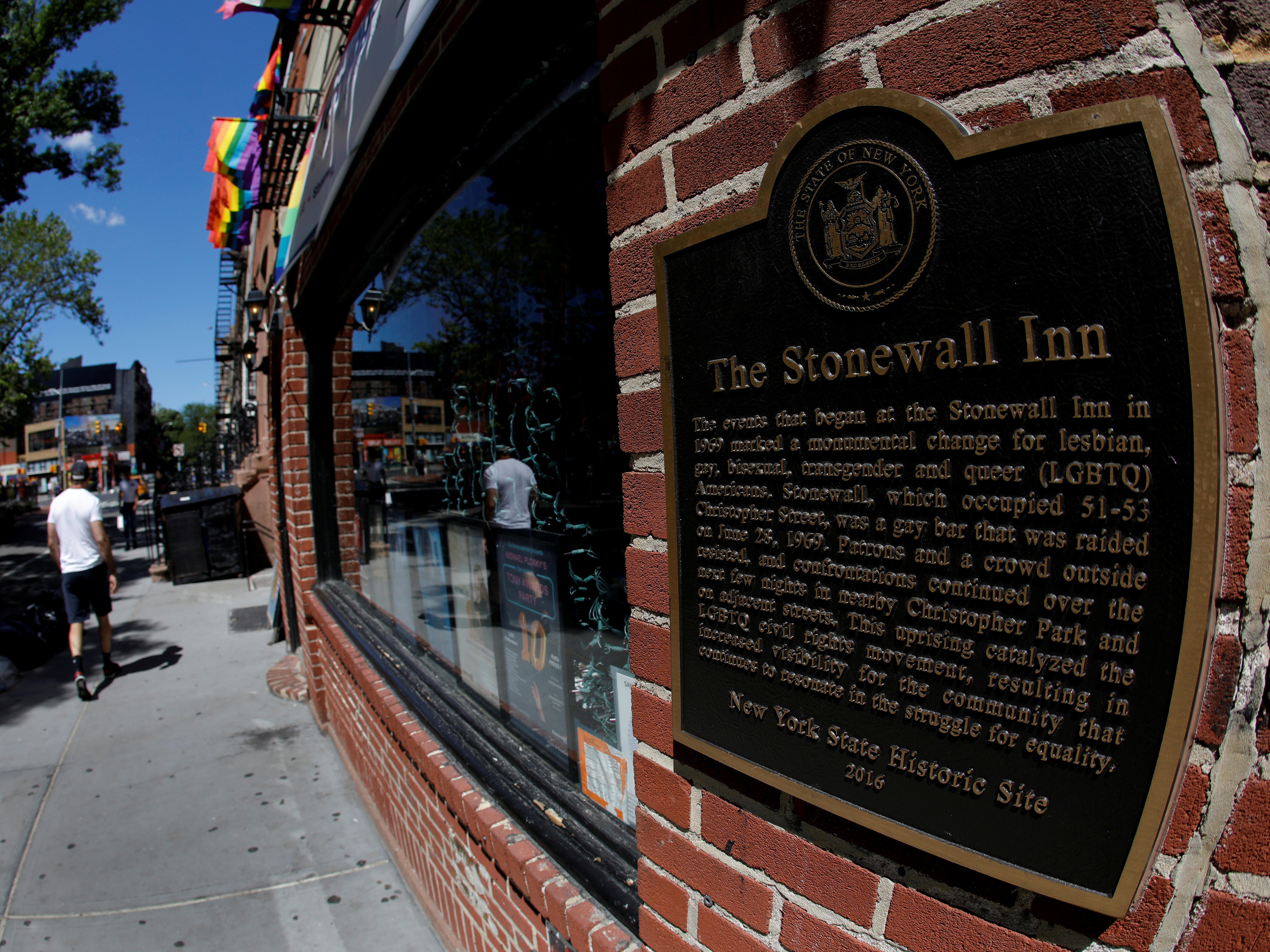 caption: A man walks past New York's Stonewall Inn, site of the 1969 uprising considered the birth of LGBTQ movement.