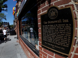 caption: A man walks past New York's Stonewall Inn, site of the 1969 uprising considered the birth of LGBTQ movement.