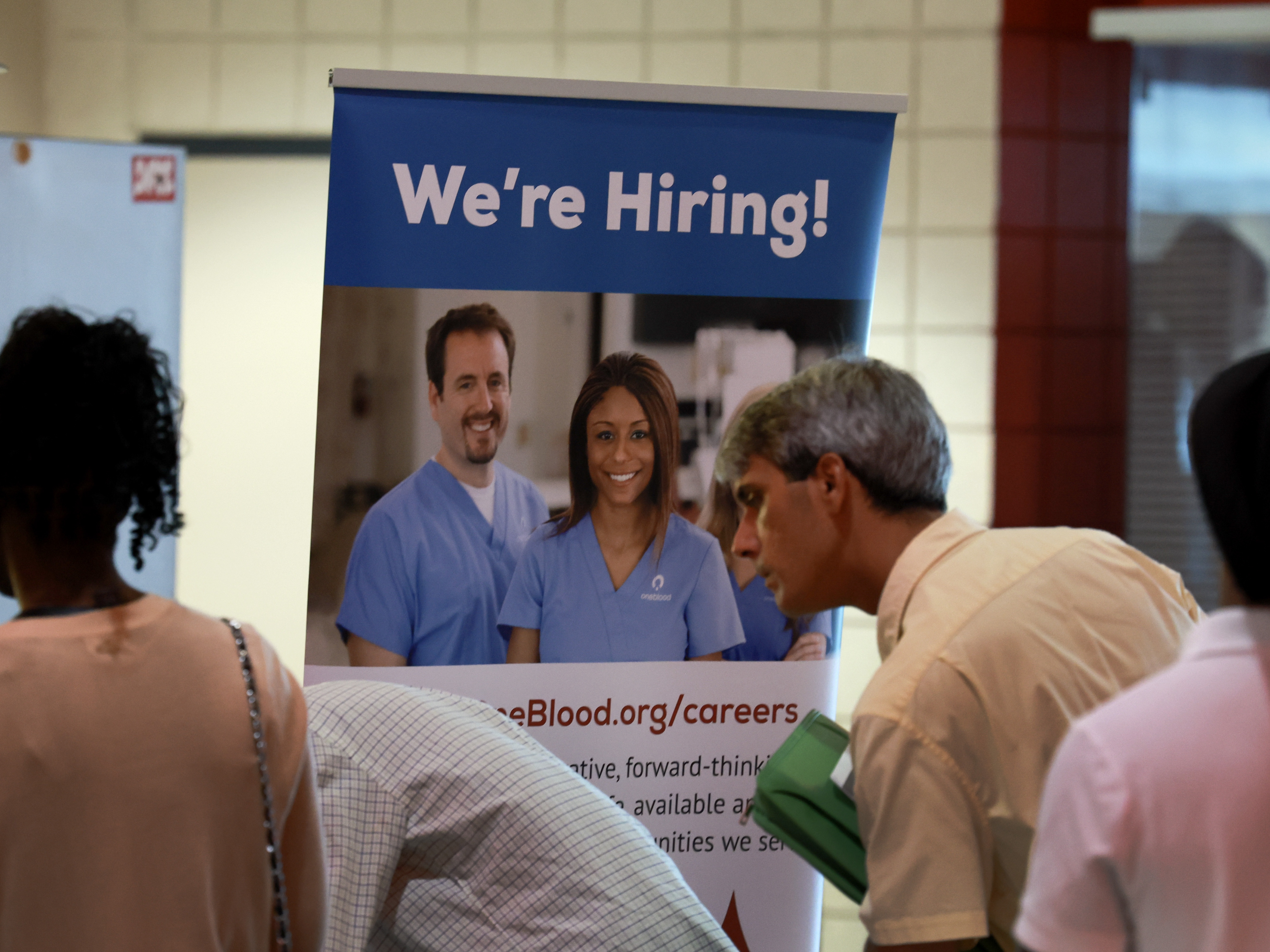 caption: Job seekers attend a job fair in Sunrise, Fl., on June 26, 2024. Employers added only 114,000 jobs last month, well below expectations, raising fears about the economy.