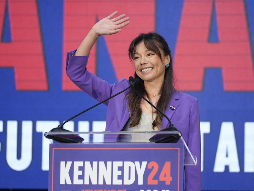 caption: Nicole Shanahan waves from the podium during a campaign event for independent presidential candidate Robert F. Kennedy Jr. Tuesday in Oakland, Calif. The California attorney is now RFK's running mate.
