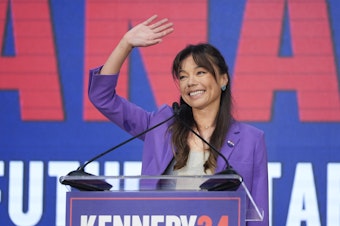 caption: Nicole Shanahan waves from the podium during a campaign event for independent presidential candidate Robert F. Kennedy Jr. Tuesday in Oakland, Calif. The California attorney is now RFK's running mate.