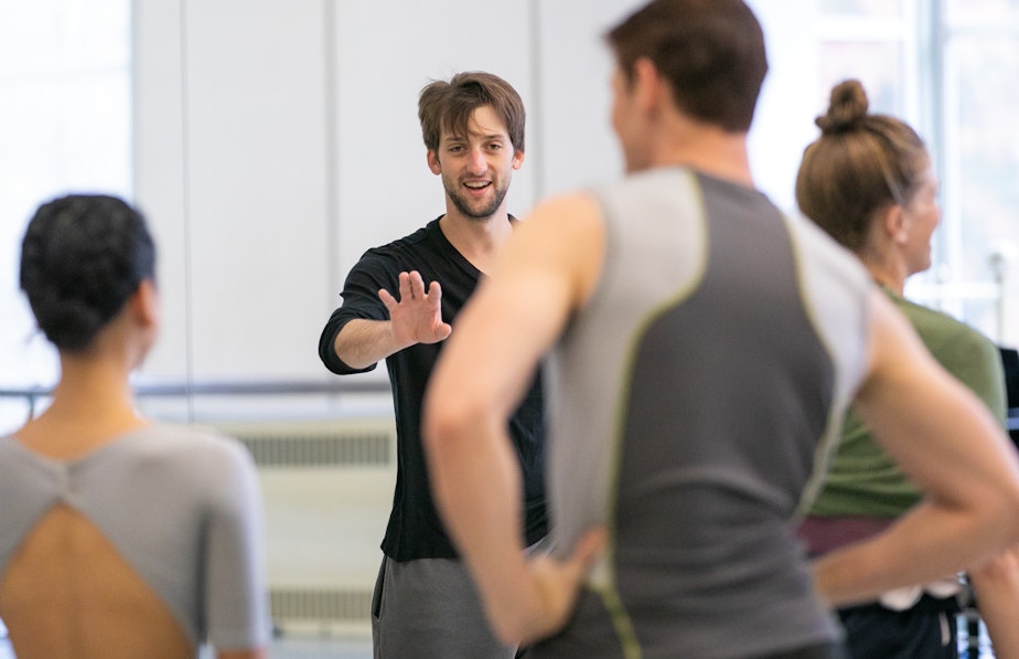 caption: Pacific Northwest Ballet dancer Miles Pertl rehearses his fellow company members for this week's debut of his ballet "Wash of Gray."