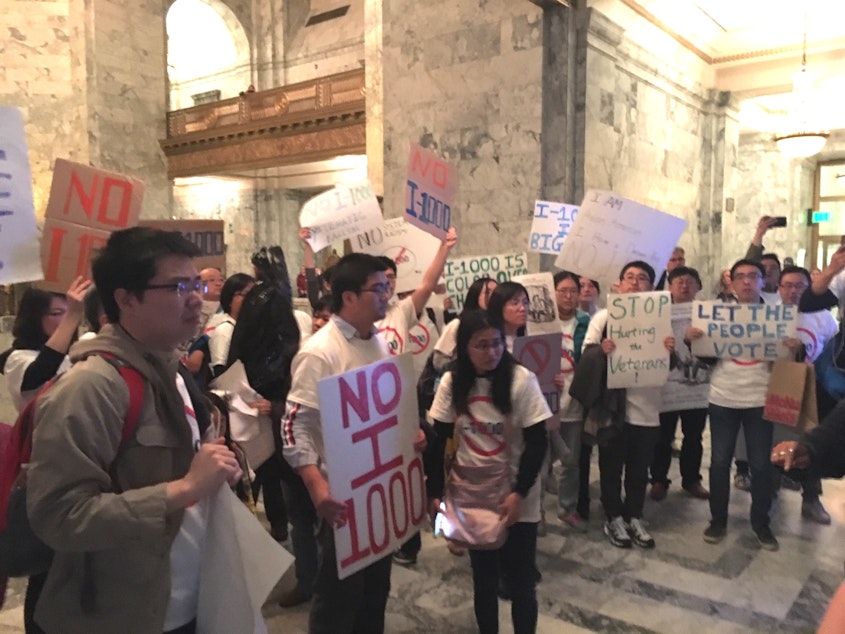 caption: Affirmative action opponents demonstrate outside the Washington Senate on Sunday night following a vote to approve I-1000.