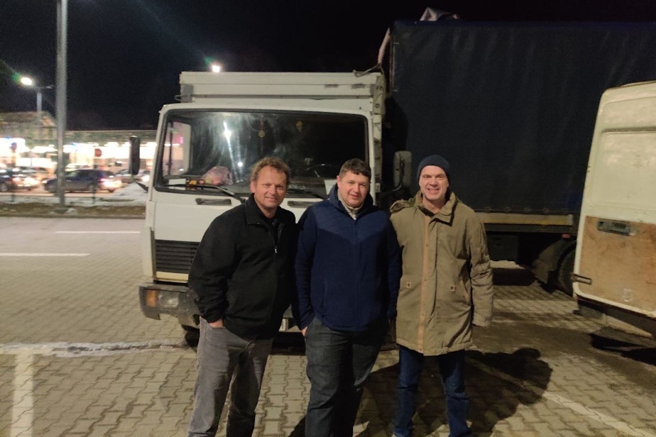 caption: Left to right: Dale Perry, his partner Yaroslav, and their colleague Willem at the drop site in Ukraine.